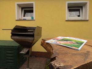 a grill sitting on a table next to a magazine at Ferienbungalow Thesenvitz in Thesenvitz +12 photos