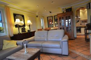 a living room with a couch and a table at Reethäuser 17 Fam Kröning in Groß Zicker