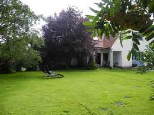 a chair sitting in the yard of a house at "Ferien vom Ich" - Fam Roman Kurth in Güstelitz +33 photos