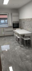 a kitchen with a table and chairs in a room at geräumige 4 Zimmer Wohnung mit Balkon in Altendorf +10 photos