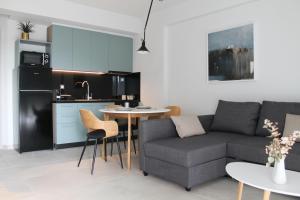 a living room with a couch and a table at AAA Luxury Residences in Ioannina