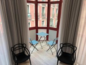 a room with chairs and a table and a window at Casual Fuentes Bilbao in Bilbao