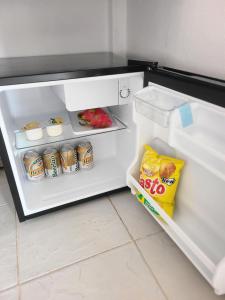 an open refrigerator with food and drinks in it at Vang Vieng Victory Hostel in Vang Vieng