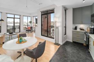a kitchen and living room with a table and chairs at Waterfront Stay With Balcony And Bbq in Victoria