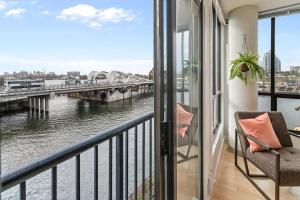 a balcony with a view of a river and a bridge at Waterfront Stay With Balcony And Bbq in Victoria