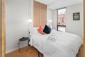 a bedroom with a white bed with two towels on it at Waterfront Stay With Balcony And Bbq in Victoria