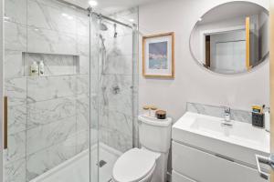 a bathroom with a shower and a toilet and a sink at Waterfront Stay With Balcony And Bbq in Victoria +31 photos