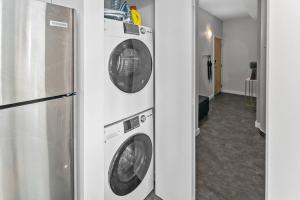 a kitchen with two washer and dryer at Waterfront Stay With Balcony And Bbq in Victoria