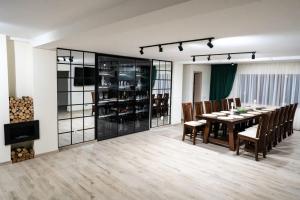 a dining room with a table and chairs at Almahaus in Avrig +18 photos