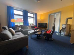 a living room with a couch and a table at Sonneck in Bad Sachsa