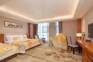 Voodi või voodid majutusasutuse Metropolo Jinjiang Yongqing Daxing International Airport Hotel toas
