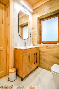 a bathroom with a sink and a mirror at Domek Jatka No 1 in Zakopane +43 photos