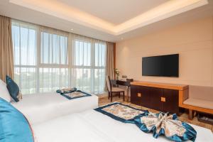 Televiisor ja/või meelelahutuskeskus majutusasutuses Metropolo Jinjiang Yongqing Daxing International Airport Hotel