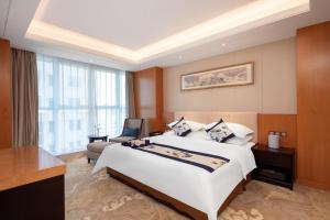 Voodi või voodid majutusasutuse Metropolo Jinjiang Yongqing Daxing International Airport Hotel toas