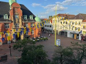 a city street with colorful flags and buildings at Buxtehude Altstadt Wohnung 84qm für 6 Personen in Buxtehude +10 photos