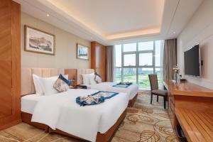Televiisor ja/või meelelahutuskeskus majutusasutuses Metropolo Jinjiang Yongqing Daxing International Airport Hotel