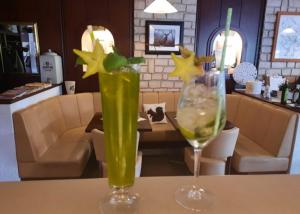 two vases sitting on a table with a wine glass at Muemling Apartments in Erbach