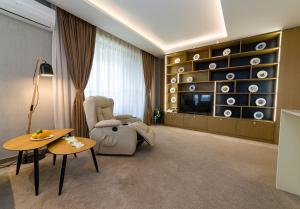 a living room with a chair and a table at City Park Inn in Plovdiv