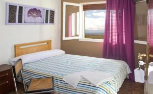 a small bedroom with a bed and a window at Hernani Bardenas in Arguedas