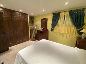 una camera con letto bianco, cassettiera e letto sidx sidx sidx. di Tomi & Fonti a Guadamur