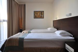 a hotel room with two beds and a window at Hotel Burgas Free University in Burgas