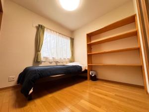 a bedroom with a bunk bed and a window at ura tomari in Okayama