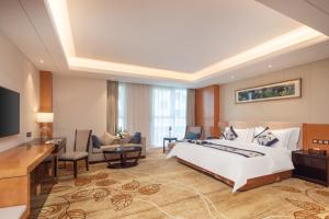 Voodi või voodid majutusasutuse Metropolo Jinjiang Yongqing Daxing International Airport Hotel toas