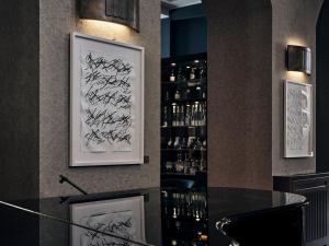 a bar with some signatures on the wall at The Wellem, in The Unbound Collection by Hyatt in Düsseldorf