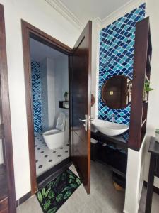 a bathroom with a toilet and a sink at Hill Top homestay in Da Thanh