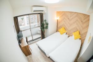 Postel nebo postele na pokoji v ubytování Royal Heights Sakuragawa Condominium