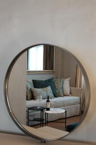 a mirror in a living room with a couch at Castellano Hotel & Suites in Nafplio