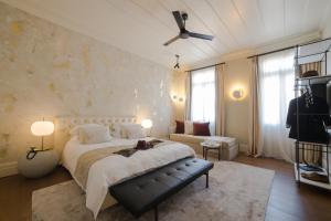 a bedroom with a large bed and a couch at Castellano Hotel & Suites in Nafplio