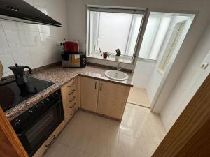 a kitchen with a sink and a counter top at Valencia Frente al mar in Valencia +8 photos