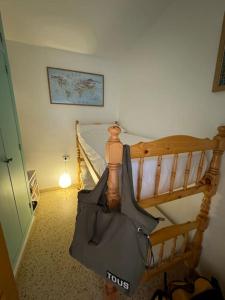 a bedroom with a wooden bed with a black umbrella at Valencia Frente al mar in Valencia