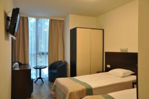 a hotel room with two beds and a window at Hotel Burgas Free University in Burgas