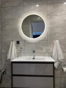 a bathroom with a white sink and a mirror at RESIDENTS IONIAN (BED AND BREAKFAST) in Argostoli