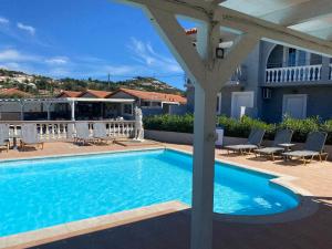 a swimming pool with a pergola next to a house at RESIDENTS IONIAN (BED AND BREAKFAST) in Argostoli