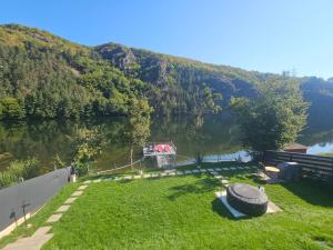 Someşu CaldGreen Rock Cabin的享有湖泊美景,在水中划船