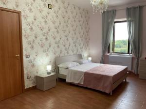 a bedroom with a bed and a window at B&B Sunset Suite Belvedere 2 in Sant'Agata de' Goti