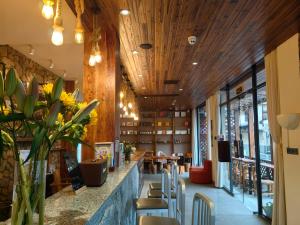 a restaurant with wooden ceilings and a bar with chairs at Guilin Village Creek Inn & Free pick up service over three nights in Guilin +123 photos