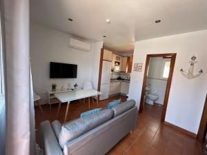 a living room with a couch and a table at Seaside Paradise Mazagon in Mazagón