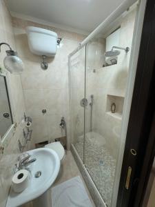 a bathroom with a shower and a sink and a toilet at Vittoria's home near Maradona mural in Naples