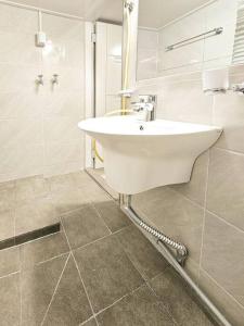 a white bathroom with a sink and a mirror at Good Stay in Seoul