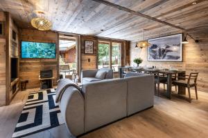 a living room with a couch and a table at Falcon Lodge by Alpine Resorts in Méribel