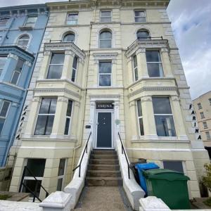 a building with a blue door and stairs in front at Farina No8, 3 bedroom Sea view apartment sleeping 7 guests in Bridlington
