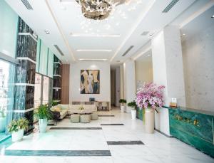 a lobby of a building with plants inpots at Areca Hotel Nha Trang in Nha Trang