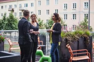 a group of three people standing in a garden at Sky Hotel Apartments, Stockholm in Stockholm