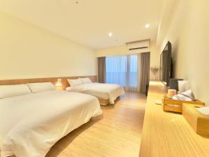 Voodi või voodid majutusasutuse Brown House Hotel - Taipei Main Station toas