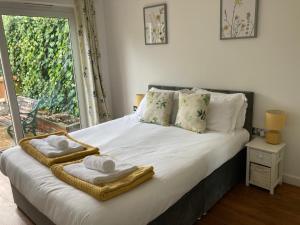a bedroom with a bed with towels on it at Park Cottage - Cosy 1 bedroom in Spinney Hill