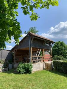a large wooden cabin in a field of grass at Gîte de Lagarde in Saint-Cernin